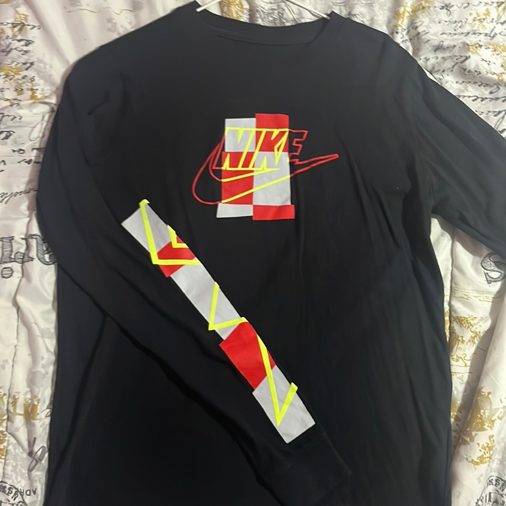 Black nike t shirt with a red, yellow and grey design down the sleeves